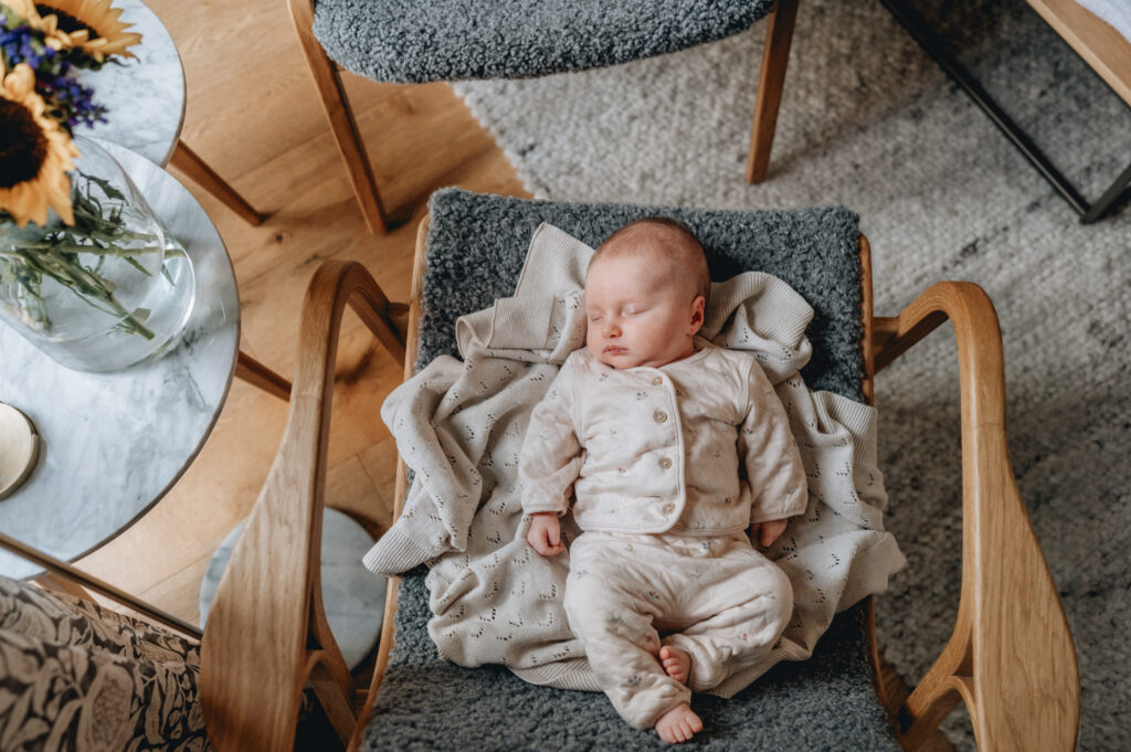 Baby asleep on a chair